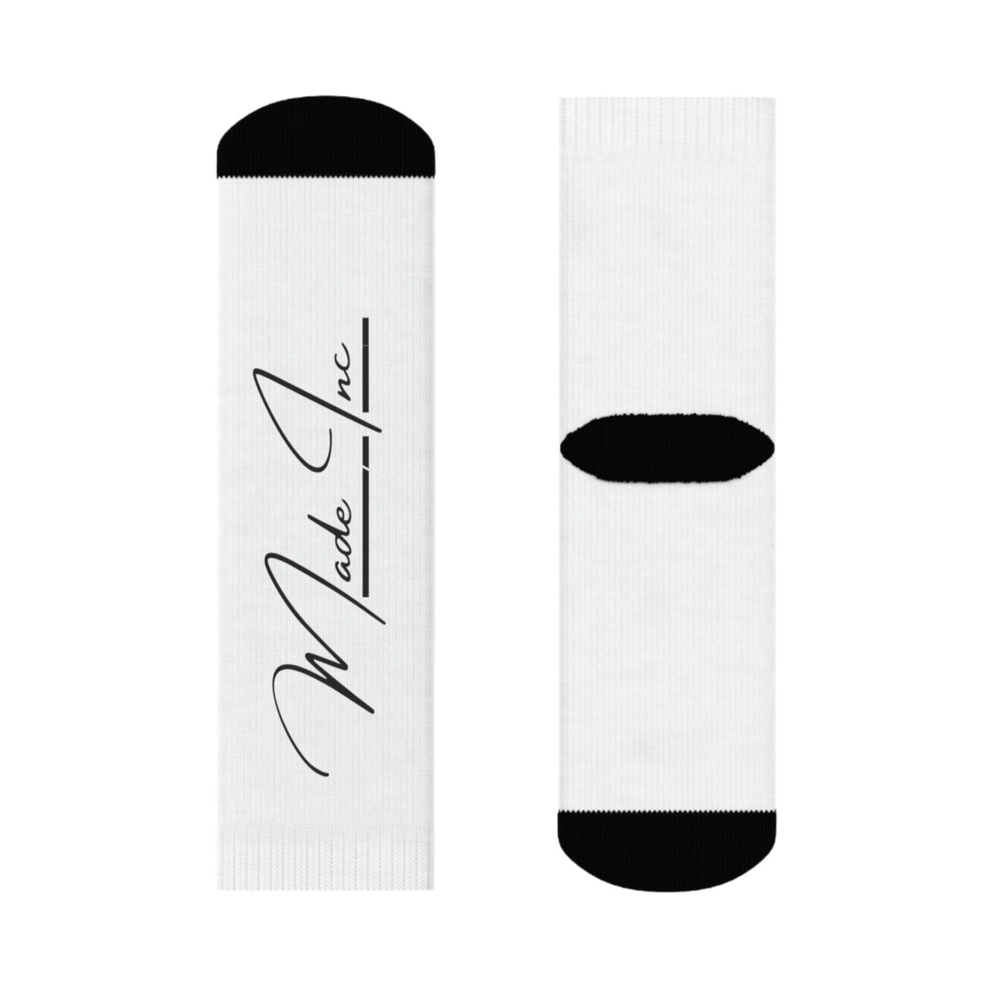 white and black pair of sublimated socks with Made Inc Signature